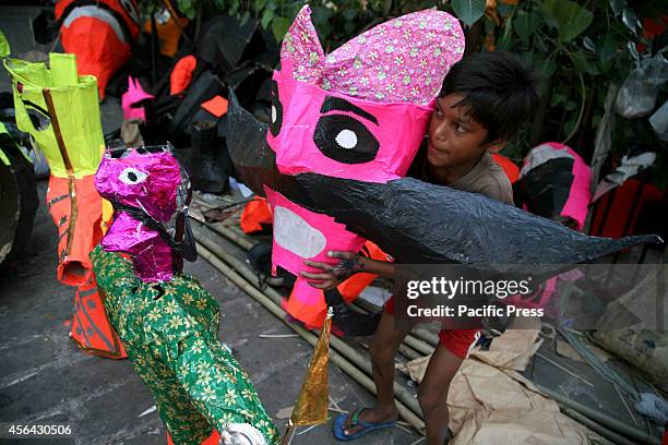 An artist prepares the effigy of Demon King Ravana for Vijaya Dashmi or Dussehara Festival in New Delhi. Hindu devotees burn effigy of Demon King...