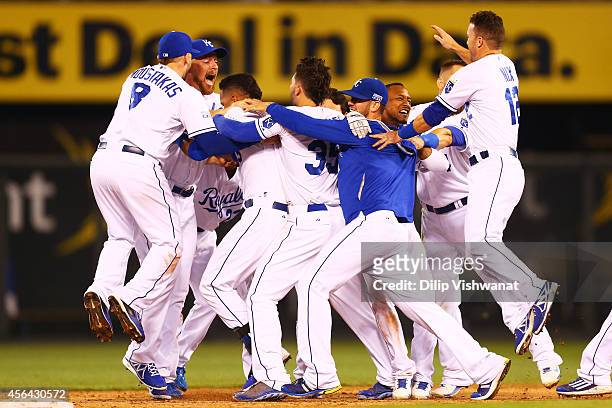 The Kansas City Royals celebrate their 9 to 8 win over the Oakland Athletics in the 12th inning of their American League Wild Card game at Kauffman...