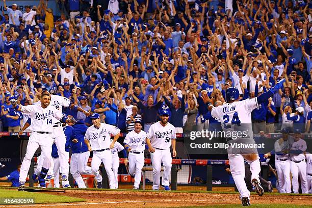 The Kansas City Royals celebrate their 9 to 8 win over the Oakland Athletics in the 12th inning of their American League Wild Card game at Kauffman...