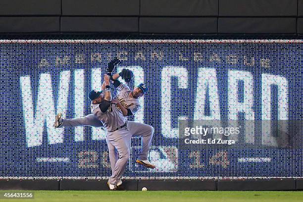 Jonny Gomes and Sam Fuld of the Oakland Athletics collide on a triple hit by Eric Hosmer of the Kansas City Royals in the 12th inning during the...