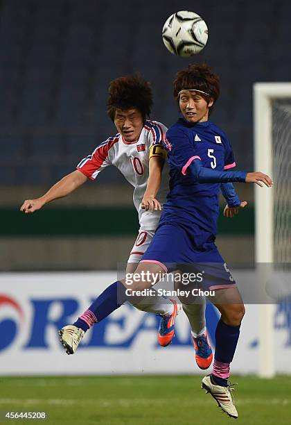 Kana Osafune of Japan and Ra Unsim of North Korea compete for the ball during the Football Women's Gold Medal match between North Korea and Japan...