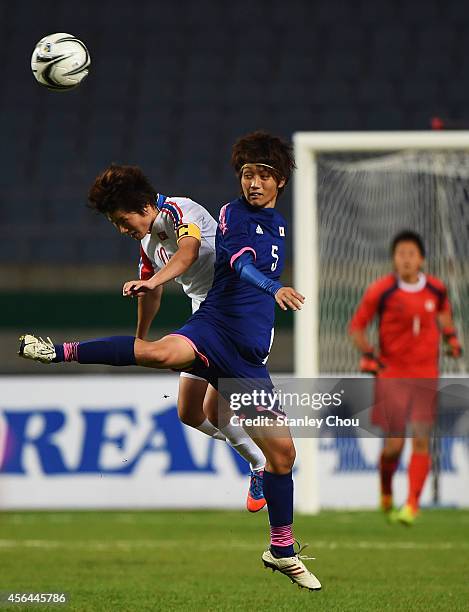 Kana Osafune of Japan and Ra Unsim of North Korea compete for the ball during the Football Women's Gold Medal match between North Korea and Japan...