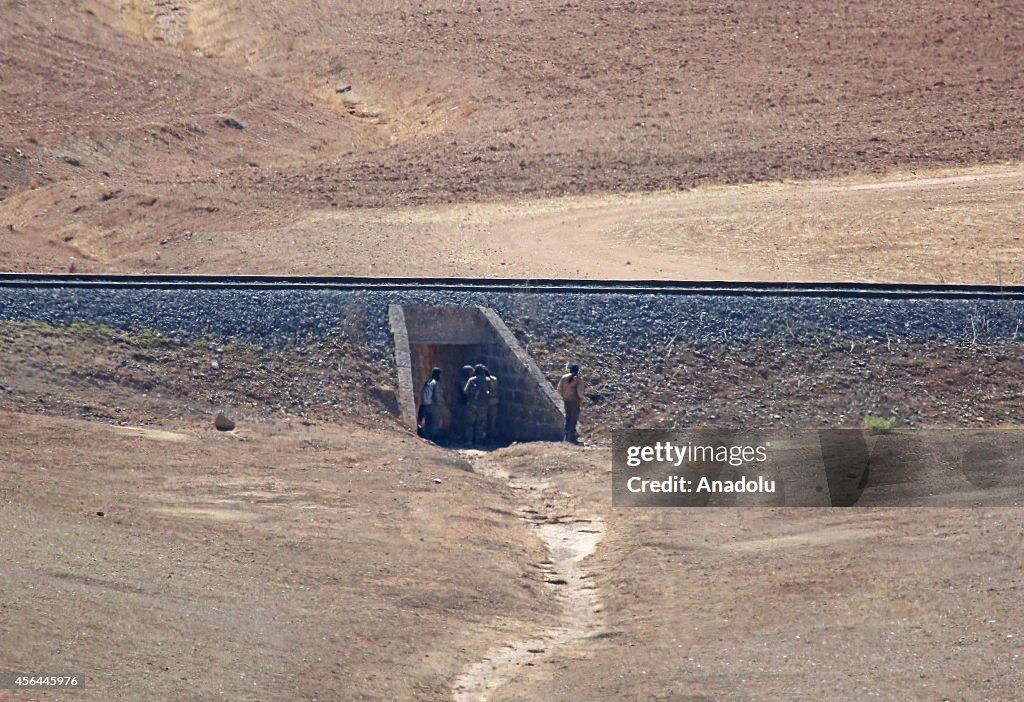 ISIL militants fight against the Kurdish armed groups