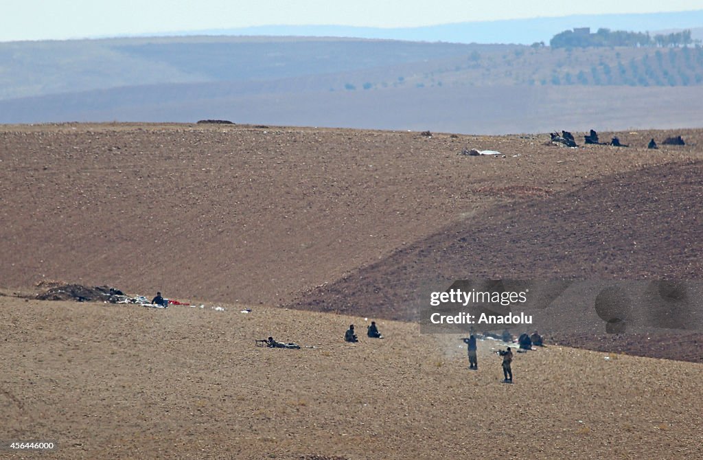 ISIL militants fight against the Kurdish armed groups...