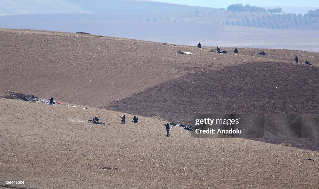 ISIL militants fight against the Kurdish armed groups...