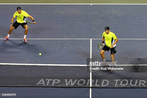 Bob Bryan and Mike Bryan of USA in action during the men's doubles first round match against Pierre-Hugues Herbert of France and Michal Przysiezny of...