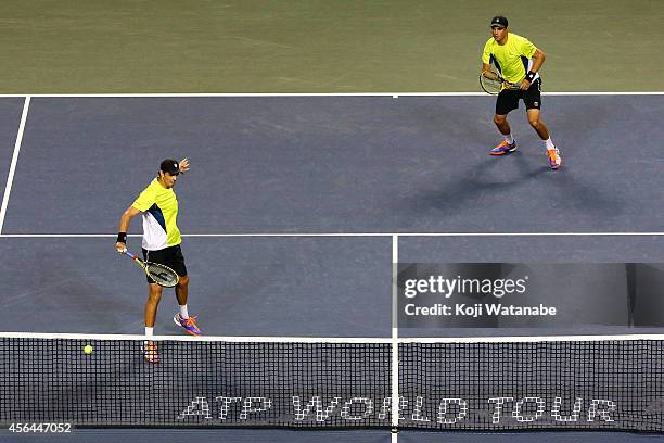 Bob Bryan and Mike Bryan of USA in action during the men's doubles first round match against Pierre-Hugues Herbert of France and Michal Przysiezny of...