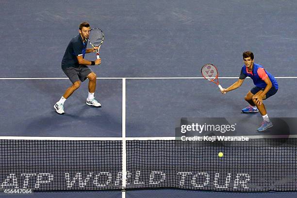 Pierre-Hugues Herbert of France and Michal Przysiezny of Poland in action during the men's doubles first round match against Bob Bryan and Mike Bryan...