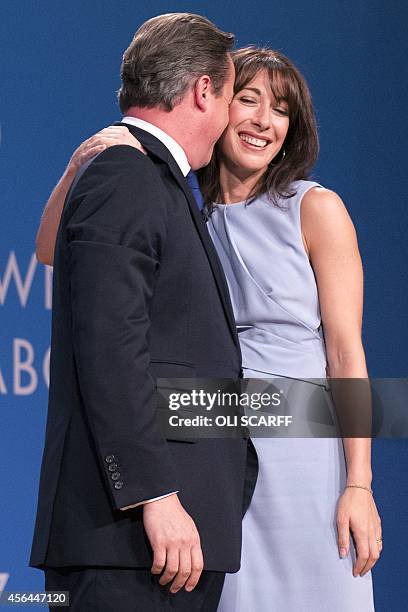 British Prime Minister David Cameron embraces his wife Samantha following his keynote speech on the final day of the annual Conservative Party...