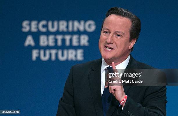 Prime Minister David Cameron gestures as he delivers his keynote speech to the Conservative party conference on October 1, 2014 in Birmingham,...