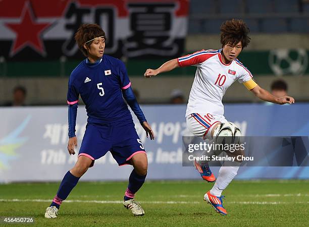 Ra Unsim of North Korea and Kana Osafune of Japan compete for the ball during the Football Women's Gold Medal match between North Korea and Japan...