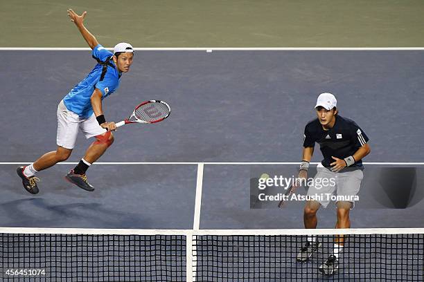 Tatsuma Ito and Go Soeda of Japan in action during the men's doubles first round match against Rohan Bopanna and Leander Paes of India on day three...