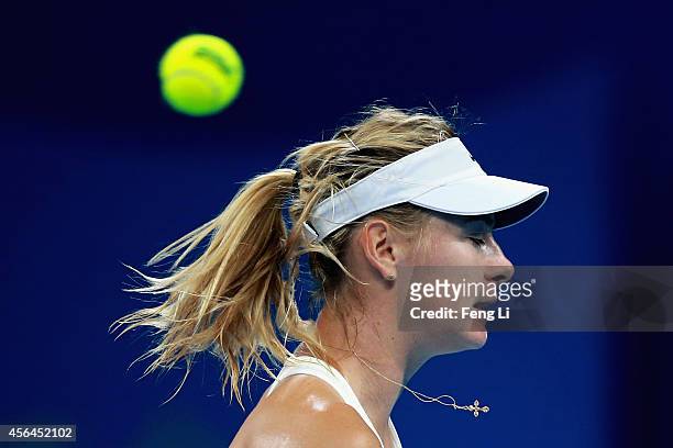 Maria Sharapova of Russia misses a ball against Carla Suarez Navarro of Spain during day five of the China Open at the China National Tennis Center...