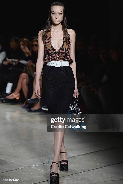 Model walks the runway at the Miu Miu Spring Summer 2015 fashion show during Paris Fashion Week on October 1, 2014 in Paris, France.