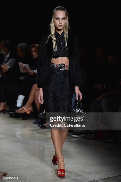 Model walks the runway at the Miu Miu Spring Summer 2015 fashion show during Paris Fashion Week on October 1, 2014 in Paris, France.