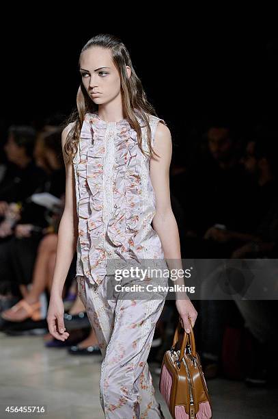 Model walks the runway at the Miu Miu Spring Summer 2015 fashion show during Paris Fashion Week on October 1, 2014 in Paris, France.