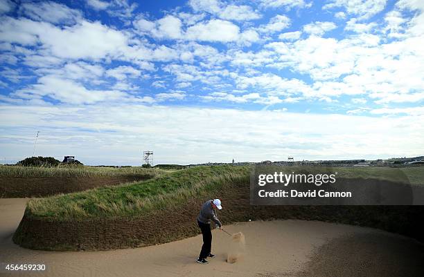 Ernie Els of South Africa plays out from the Hell bunker on the 14th hole during the final practice round prior to the 2014 Alfred Dunhill Links...