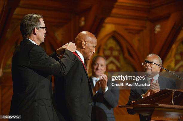 Harry Belafonte receives the W.E.B. Du Bois Medal from Glenn Hutchins at Harvard University's Sanders Theatre on September 30, 2014 in Cambridge,...