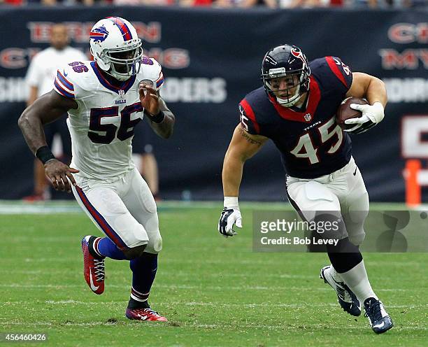 Jay Prosch of the Houston Texans runs with the ball as he is pursued by Keith Rivers of the Buffalo Bills at NRG Stadium on September 28, 2014 in...