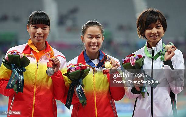 Gold medalist Wu Shuijiao of China, Silver medalist Sun Yawei of China and Bronze medalist Ayako Kimura of Japan pose during the medal ceremony of...