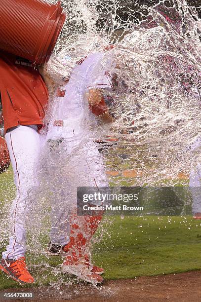 Tony Campana of the Los Angeles Angels of Anaheim is doused in water by teammate Hector Santiago after the game against the Seattle Mariners on...