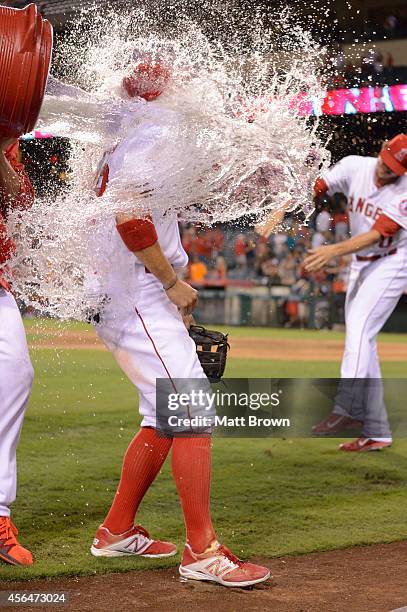 Tony Campana of the Los Angeles Angels of Anaheim is doused in water by teammate Hector Santiago after the game against the Seattle Mariners on...