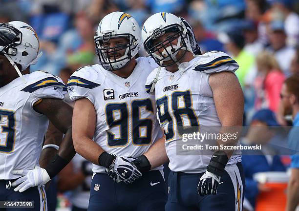 Jarret Johnson of the San Diego Chargers celebrates their imminent victory with Sean Lissemore during NFL game action against the Buffalo Bills at...