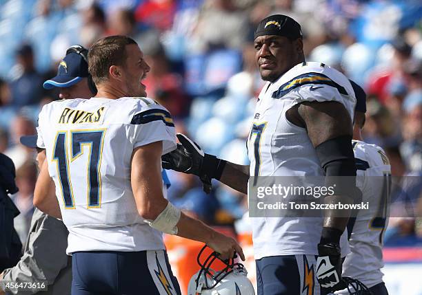 Philip Rivers of the San Diego Chargers talks to King Dunlap during NFL game action against the Buffalo Bills at Ralph Wilson Stadium on September...