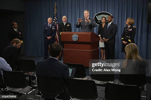 Deputy Secretary of Defense Bob Wonk speaks as Lieutenant General Thomas Travis of the Air Force, Vice Admiral Matthew Nathan of the Navy, Principal...