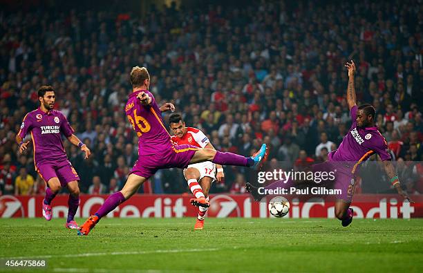 Alexis Sanchez of Arsenal scores his team's third goal during the UEFA Champions League group D match between Arsenal FC and Galatasaray AS at...