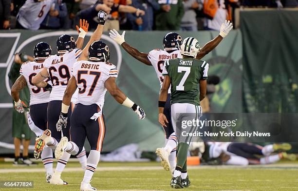 New York Jets quarterback Geno Smith watches as his pass is intercepted and returned for a touchdown in the first half when the New York Jets played...