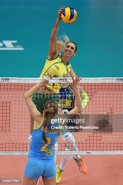 Thaisa Menezes of Brazil spikes as Lyudmila Issayeva of Kazakhstan blocks during the FIVB Women's World Championship pool F match between Brazil and...