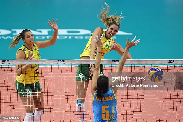 Thaisa Menezes of Brazil spikes as Olga Nassedkina of Kazakhstan blocks during the FIVB Women's World Championship pool F match between Brazil and...