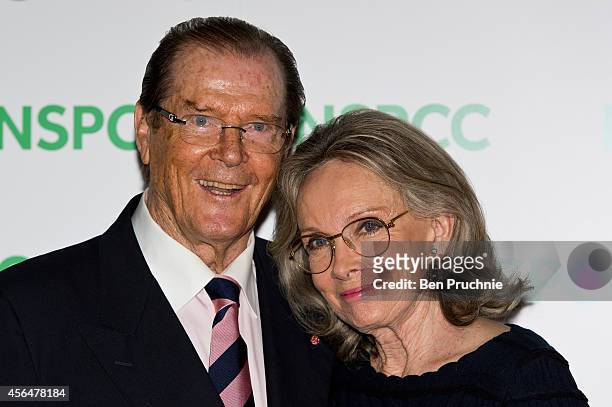 Roger Moore and Kristina Tholstrup attends A Night Out With Michael Caine at Royal Albert Hall on October 1, 2014 in London, England.