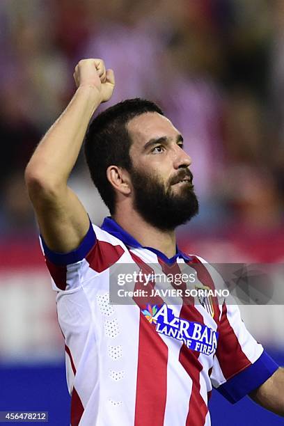 Atletico Madrid's Turkish midfielder Arda Turan celebrates after scoring their first team goal during the UEFA Champions League group A football...