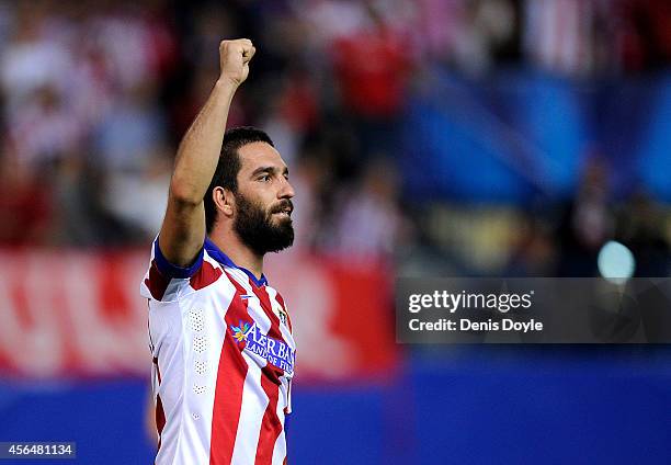 Arda Turan of Club Atletico de Madrid celebrates after scoring his team's opening goal during the UEFA Champions League Group A match between Club...