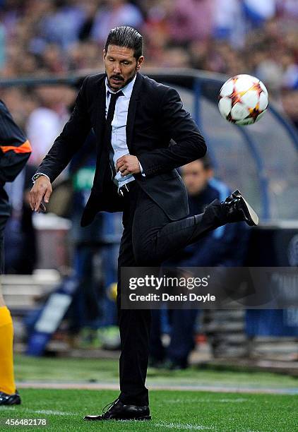 Head coach Diego Simeone of Club Atletico de Madrid controls the ball during the UEFA Champions League Group A match between Club Atletico de Madrid...