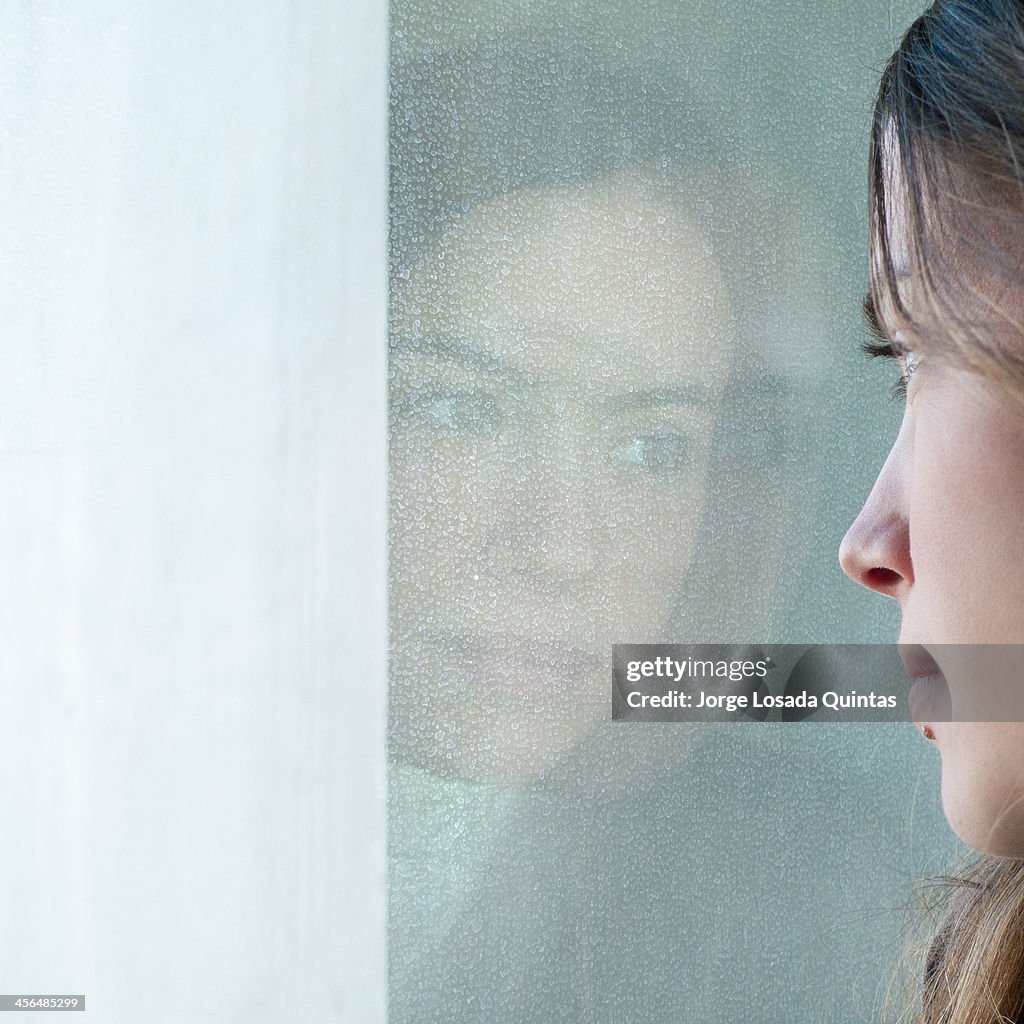 A young and beauty girl reflected in the mirror