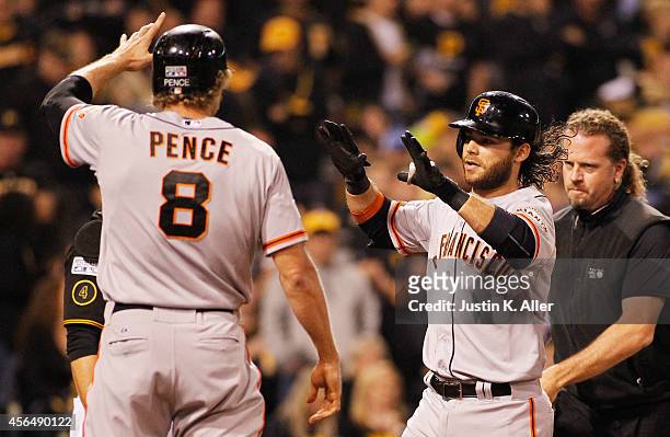 Brandon Crawford of the San Francisco Giants celebrates with Hunter Pence after hitting a four-run home run in the fourth inning against the...