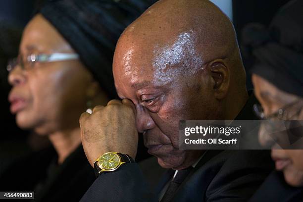 South African president Jacob Zuma wipes an eye as he sits with Graca Machel , widow of Nelson Mandela, and Winnie Mandela during an African National...