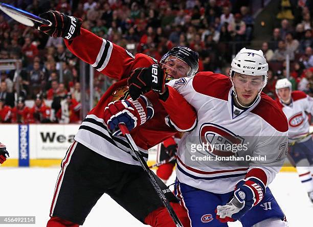 Jonathan Toews of the Chicago Blackhawks battles for position with Alexei Emelin of the Montreal Canadiens during a preason game at the United Center...