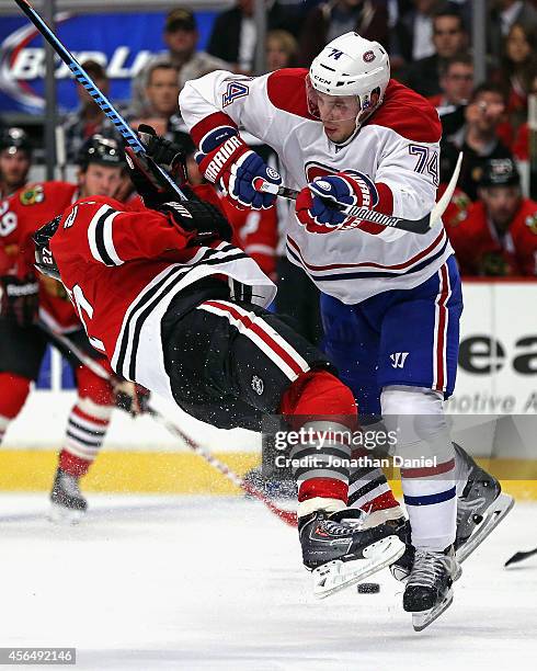 Alexei Emelin of the Montreal Canadiens hits Johnny Oduya of the Chicago Blackhawks during a preason game at the United Center on October 1, 2014 in...