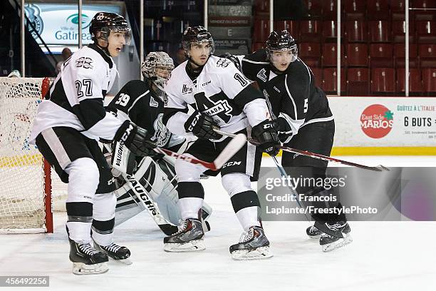 Samuel Tremblay and Fabrizio Ricci of the Blainville-Boisbriand Armada battles for position against Anthony Brodeur and Elie Berube of the Gatineau...