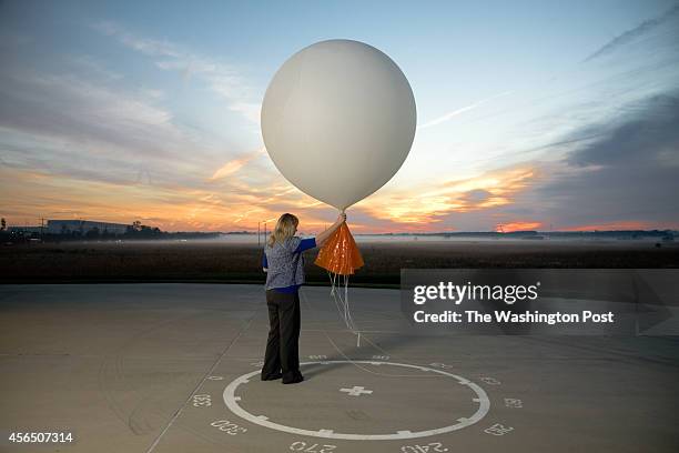 Meteorologist, Carrie Suffern Prepares to Release the Weather Balloon at National Weather Service Headquarters on October 1, 2012 in Sterling Virginia