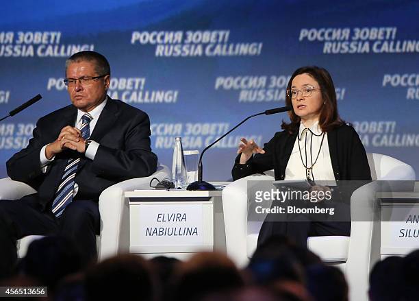 Alexey Ulyukaev, Russia's economy minister, left, sits and listens as Elvira Nabiullina, chairman of Russia's central bank, speaks during the VTB...