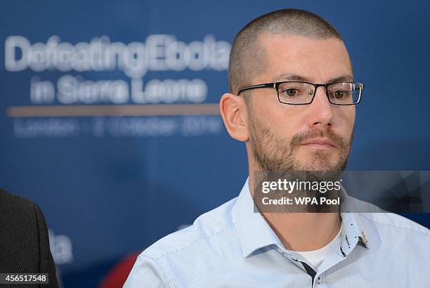 British Ebola survivor William Pooley listens as he attends the "Defeating Ebola: Sierra Leone" conference at Lancaster House on October 2, 2014 in...