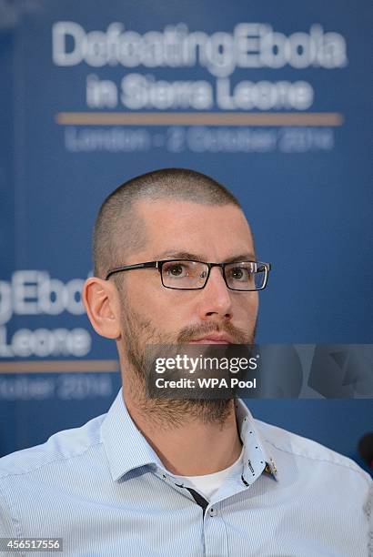 British Ebola survivor William Pooley listens as he attends the "Defeating Ebola: Sierra Leone" conference at Lancaster House on October 2, 2014 in...