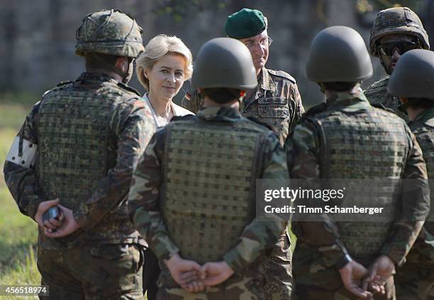 German Defence Minister Ursula von der Leyen and German General Gert-Johannes Hagemann talk to Peshmerga fighters on October 02, 2014 in Hammelburg,...