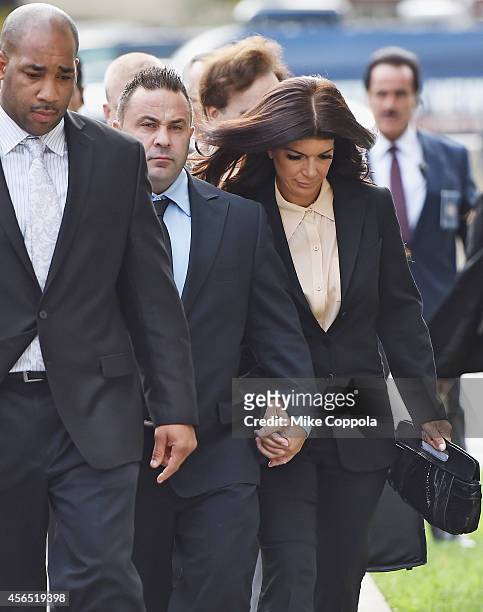 Joe Giudice and wife Teresa Giudice arrive for sentencing at federal court in Newark on October 2, 2014 in Newark, New Jersey.