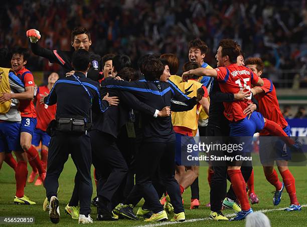 Rim Changwoo of South Korea celebrates scoring his team's first goal with his teammates during the Football Men's Gold Medal match between South...